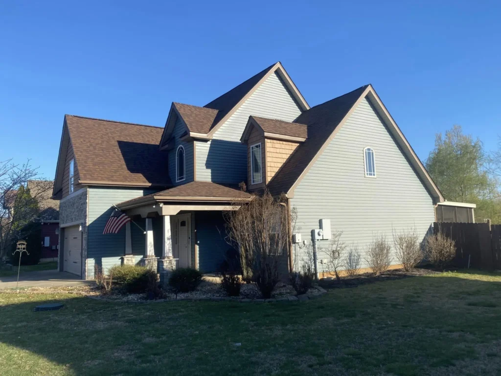 A finished roof on a two-story blue house