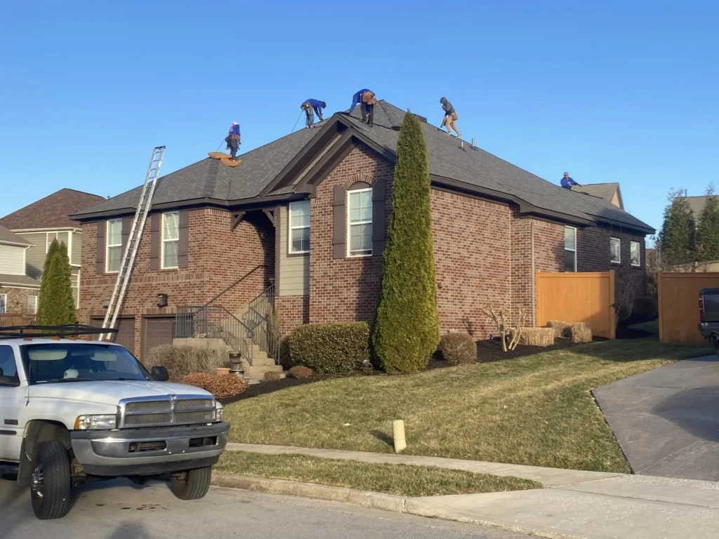 TriStar crew working on the roof of a brick house
